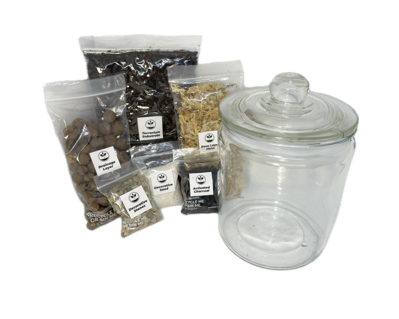 Close up photo of a diy jar terrarium kit, including glassware and substrates